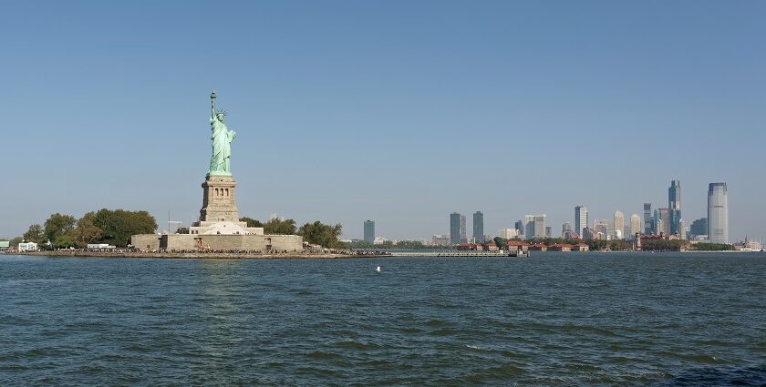 Liberty Island with the Statue of Liberty and downtown Jersey City, one of the best things to do in New Jersey.