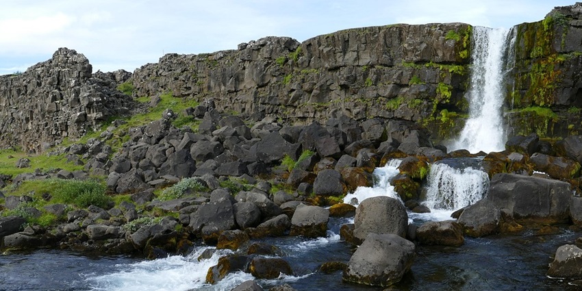 Thingvellir National Park, showcasing a waterfall, is among the places to visit in Iceland in June.