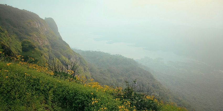 An image of two friends having fun while enjoying the scenic sunset in Lonavala.