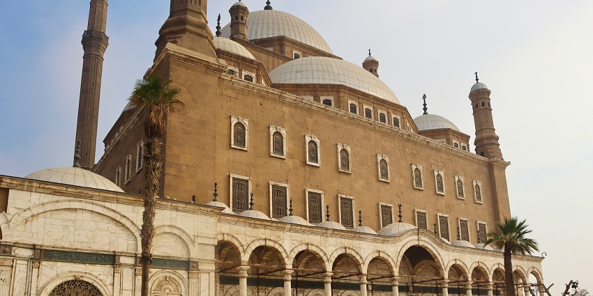 A bunch of tourists is approaching the entrance of the Citadel of Saladin in Cairo.