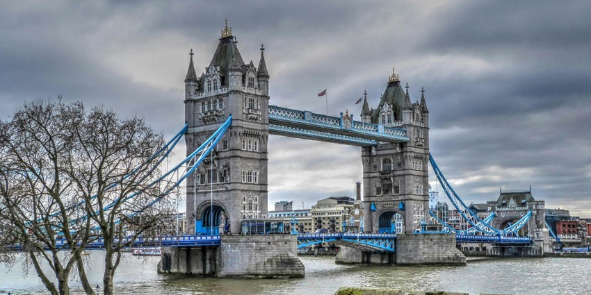 An image of Tower Bridge at night, a famous place to visit in London, England.