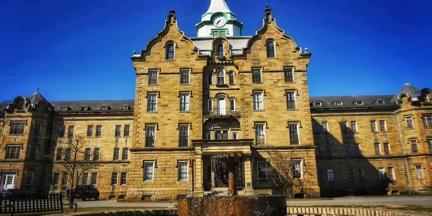 An image of the Trans-Allegheny Lunatic Asylum, a former hospital with a dark and haunted past.