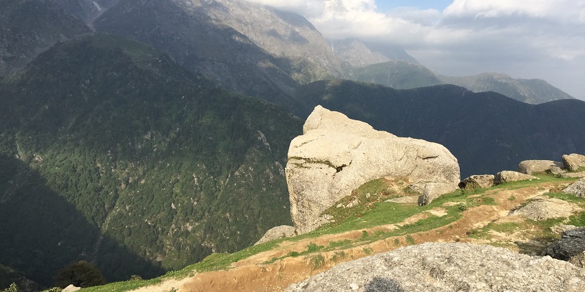Scenic hill offering panoramic views of the Dhauladhar mountains.