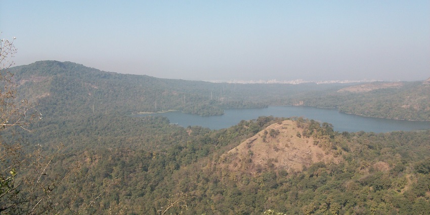 An image of Tulsi Lake with the view of lush green mountain