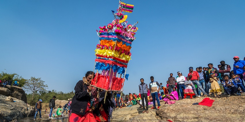 A farmer carries freshly harvested crops home in rural Jharkhand