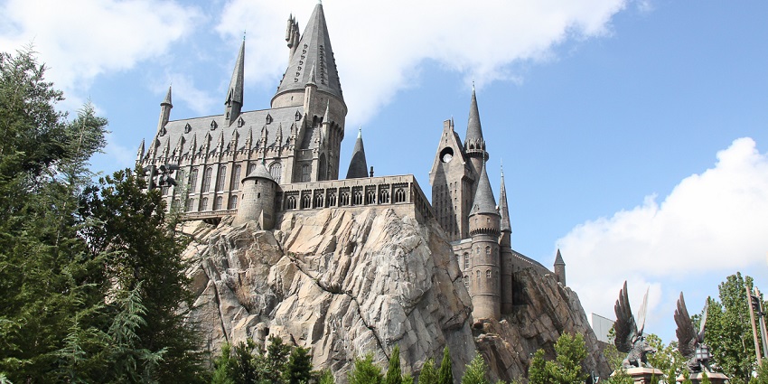 Hogwarts Castle replica in the Islands of Adventure, surrounded by greenery in Orlando