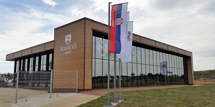 This image has a flag and an airport view stating the symbol and something written on buildings.