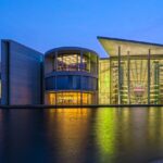 Berlin Mitte with historical and modern buildings facing the spree river during blue hour