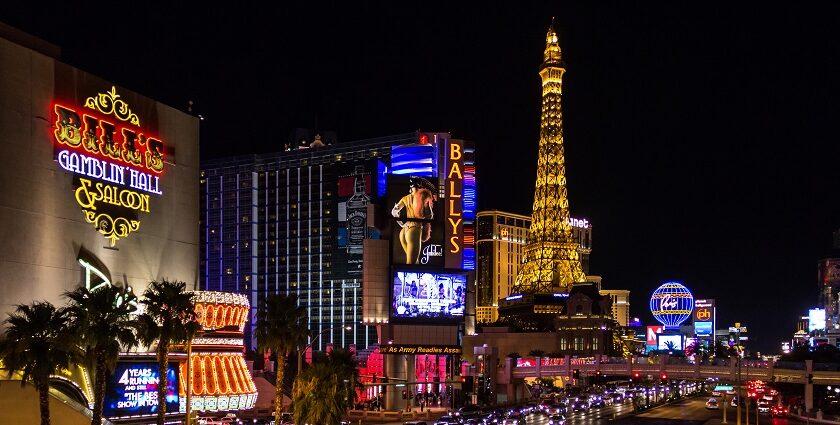 An image showcasing a vibrant Las Vegas Strip with illuminated hotels and bustling traffic.