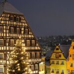 Schwäbisch Hall with buildings' roofs covered in snow and trees decorated with lights