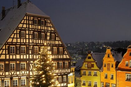 Schwäbisch Hall with buildings' roofs covered in snow and trees decorated with lights