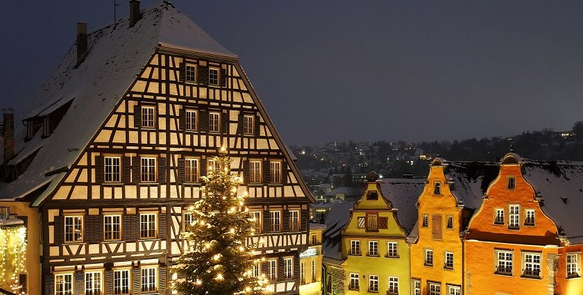 Schwäbisch Hall with buildings' roofs covered in snow and trees decorated with lights