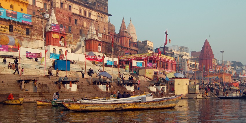 A boatman stands on his boat near one of the ghats along the Ganges in Varanasi.
