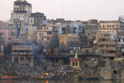 A group of people perform last rites at a cremation ground on the bank of the Ganges in Varanasi, UP.