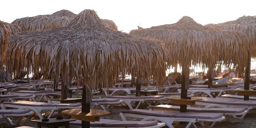 Image of Deckchairs Under Umbrellas on the Varkiza Beach in Greece during day time
