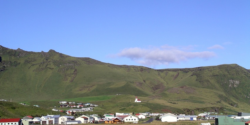An image of Vík í Mýrdal Beach in Iceland, featuring black sand and dramatic coastal views.
