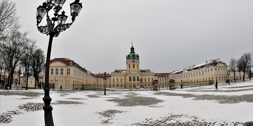Outside the Charlottenburg palace with a street lamp and area covered in light snow
