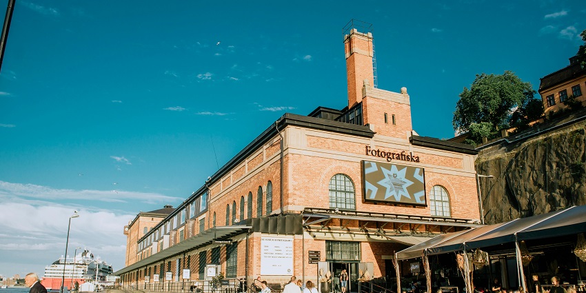 Outside the Fotografiska Museum with its historic structure and stairs and road in front.