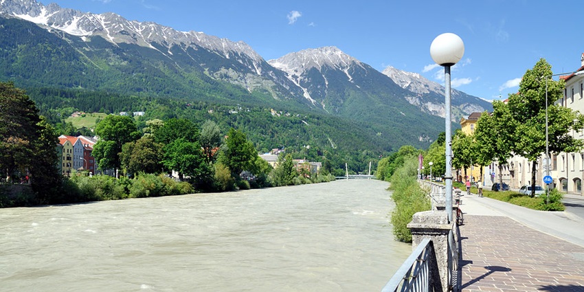 A view of the scenic mix of urban life and mountain views in Innsbruck, Austria