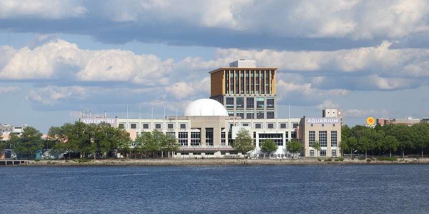 Building of adventure aquarium across the river with Aquarium signage on the front wall