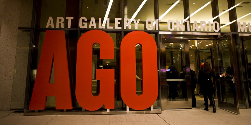 Entrance of Art Gallery of Ontario featuring the glass doors and a signboard, one of the best things to do in Toronto.