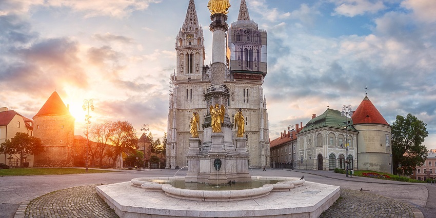 A sunrise view of the skyline-touching Gothic architecture of the Cathedral of Zagreb.