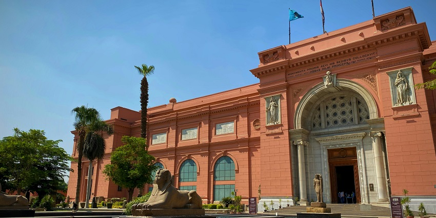 The front view of the Egyptian Museum featuring a Sphinx statue near the entrance