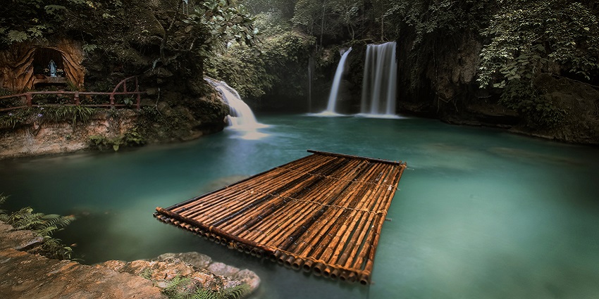 Kawasan Falls, a stunning waterfall surrounded by lush greenery