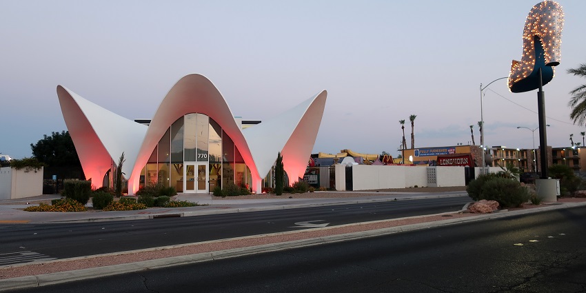 Building of the Neon Museum with unique architecture, glass doors and a heel-shaped pole
