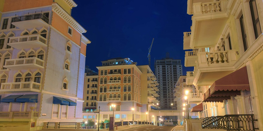Luxurious island featuring shops, restaurants, and waterfront views.