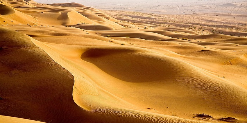 The Oman travel guide features an expansive desert with golden dunes and Bedouin culture.