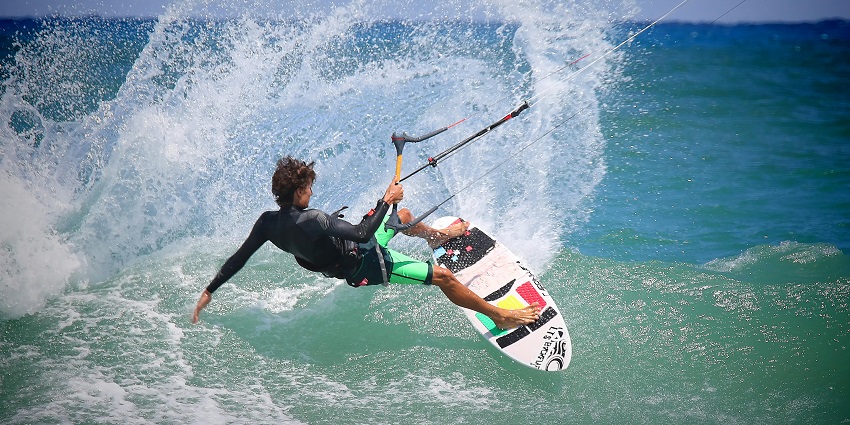 An image of a woman surfer enjoying surfing, one of the best water sports in Maharashtra.