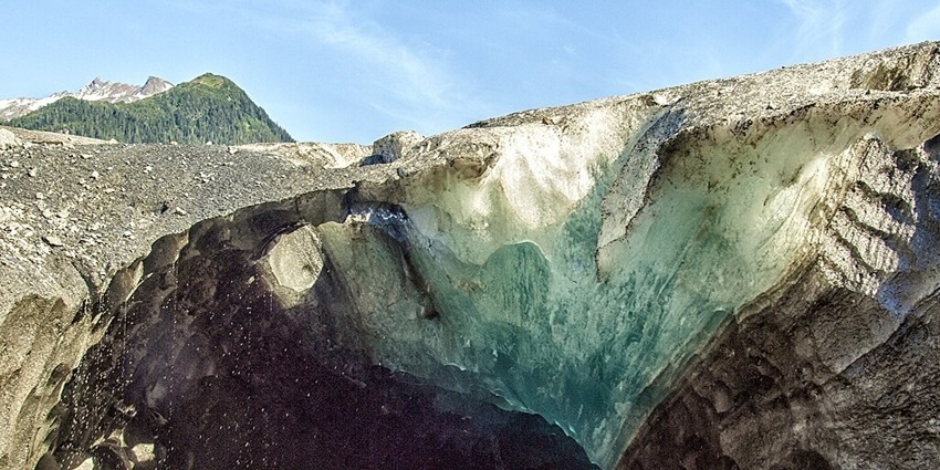 An image of ice columns in Werfen Ice Cave with a serene alpine landscape.