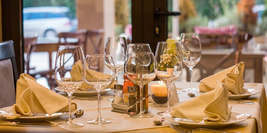 Elegant restaurant table setting with plates, cutlery, and glassware arranged neatly