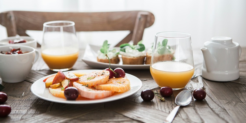 Image of breakfast served a table in restaurant or hotel with orange