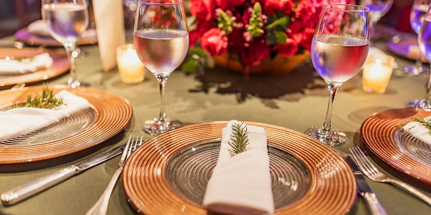 A cosy restaurant setting with wine glasses neatly arranged on wooden tables.