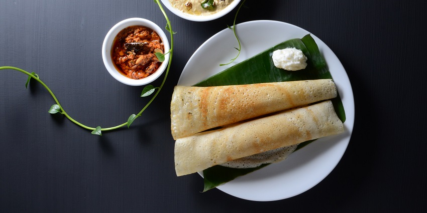Dosa served on a plantain leaf, suggested by Chikmagalur travel guide.