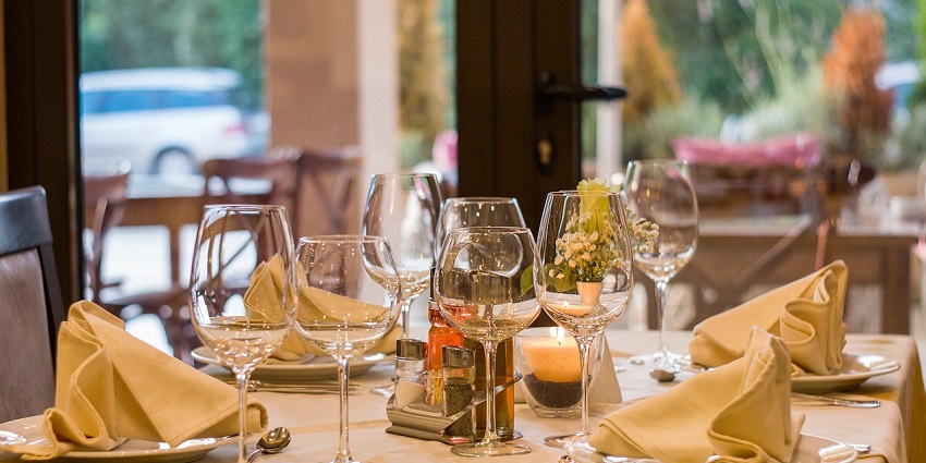 Elegant restaurant table setting with plates, cutlery, and glassware arranged neatly, near Brooklyn Museum.