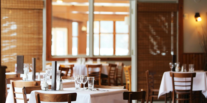 An image showing a neatly arranged dining space at a restaurant, creating a warm atmosphere.