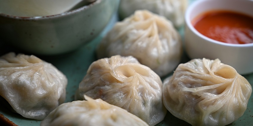 Tibetan cuisine, steamed momos served with sauce.