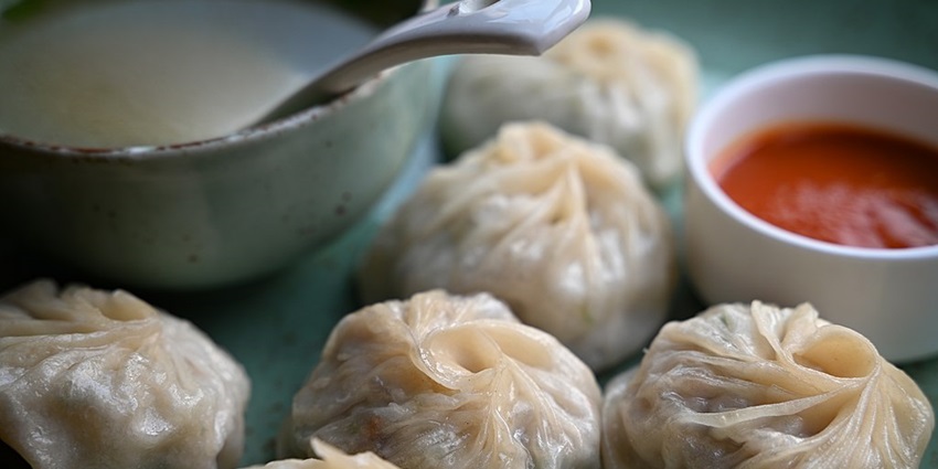 Image of the mouth-watering steamed rolled Momos being served
