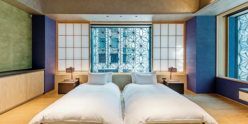 A lavish executive suite room with a view of a river from a glass window