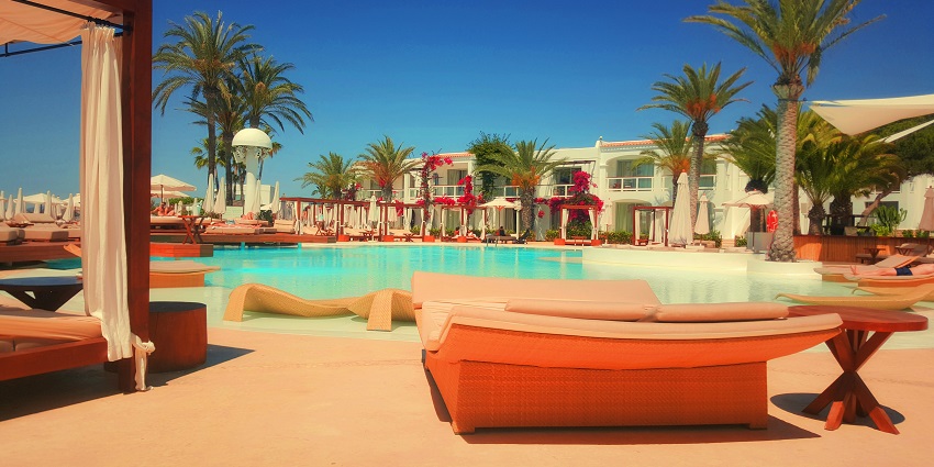 A lavish executive resort with a view of a beach and a pool area