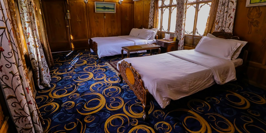 A lavish executive suite room with a view of a river from a glass window