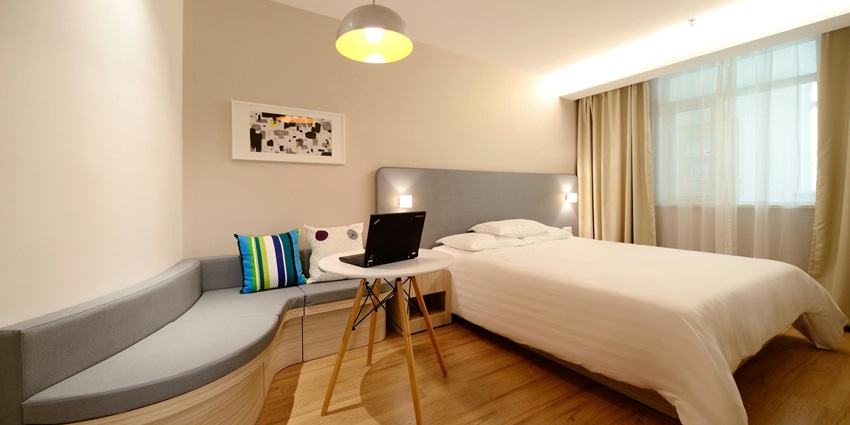 A lavish executive suite room with a view of a river from a glass window