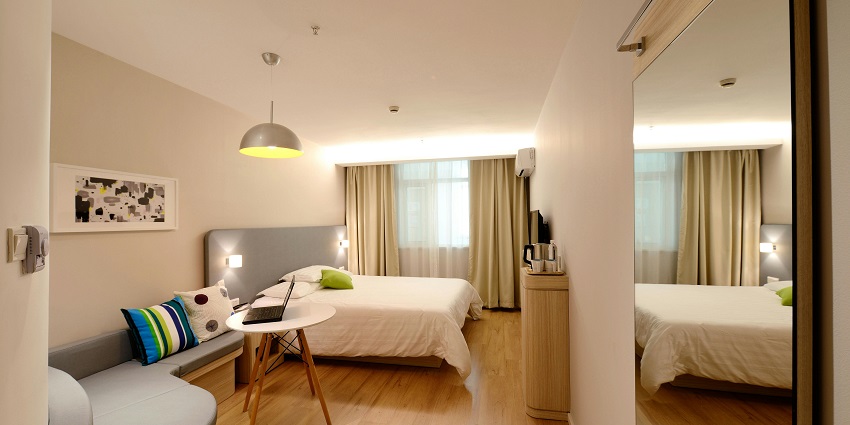 A view of a bedroom at a famous hotel near the destination in New York with two bedside tables.