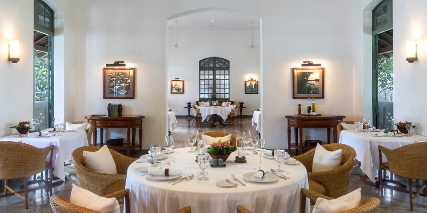 -A lavish executive suite room with a view of a river from a glass window.