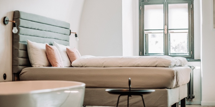 An image of an elegant bedroom with stylish decor, soft lighting, and a cosy ambience in a modern interior setting.