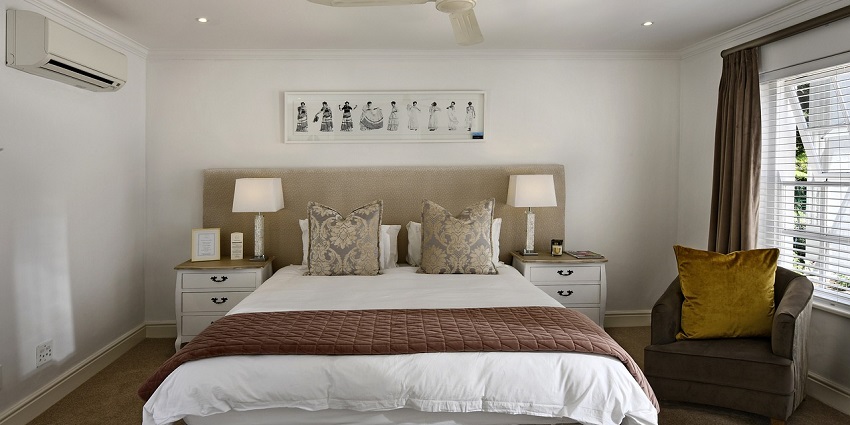 A stylish bedroom with a large bed, modern decor, and soft lighting for a relaxing atmosphere