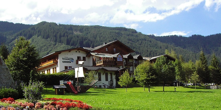 An image of Krimmler Gasthof with a view of Krimml Waterfalls in the background, Austria.